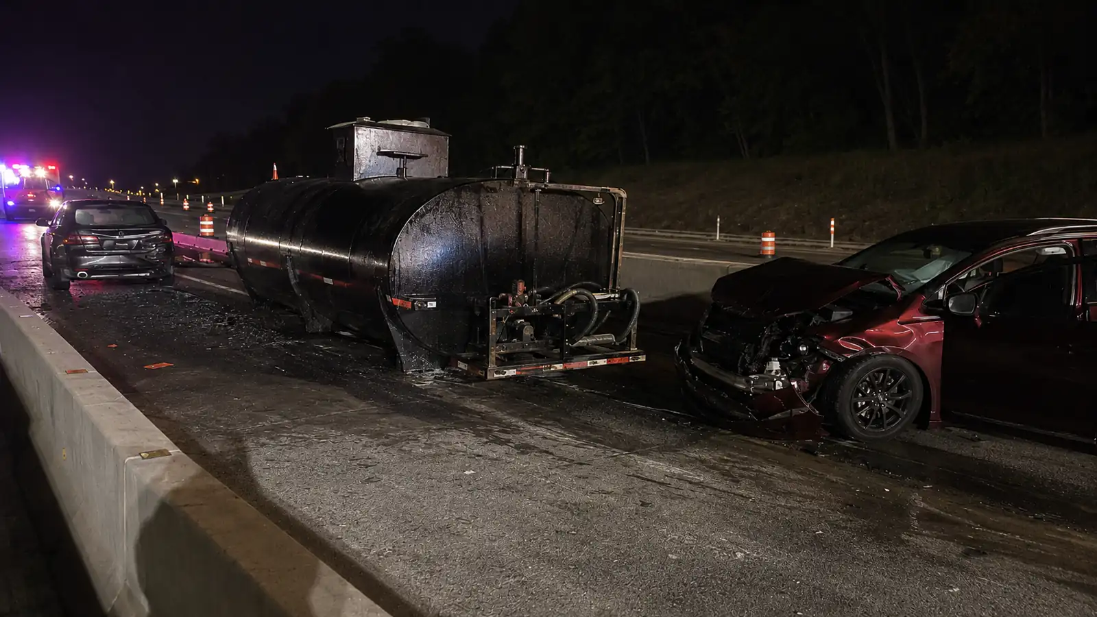 Car hits detached trailer on U.S. 131, spilling tar across roadway